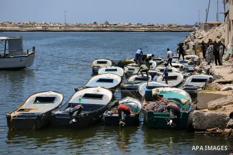 Palestinian fishermen ride their fishing boats after it was delivered by Israeli forces, in the east of Gaza city, July 03, 2019. Israel and Hamas reportedly renewed a truce agreement last week and agreed to send diesel...