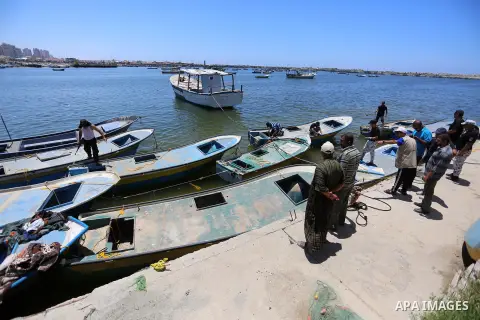 Palestinians look at fishing boats at the Gaza sea port after it was delivered by Israeli forces, in the east of Gaza city, July 03, 2019. Israel and Hamas reportedly renewed a truce agreement last week and agreed to sen...