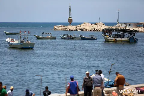 Palestinians look at fishing boats at the Gaza sea port after it was delivered by Israeli forces, in the east of Gaza city, July 03, 2019. Israel and Hamas reportedly renewed a truce agreement last week and agreed to sen...
