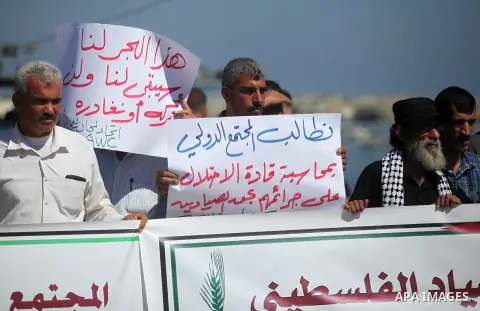 Palestinian fishermen take part in a protest against Israeli attacks for fishermen at Gaza seaport on July 04, 2019. Photo by Mahmoud Ajjour
