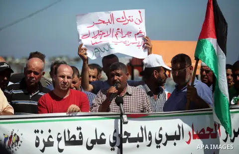 Palestinian fishermen take part in a protest against Israeli attacks for fishermen at Gaza seaport on July 04, 2019. Photo by Mahmoud Ajjour