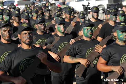 Young Palestinians, carrying a wooden rifle, chants slogans during a military-style graduation ceremony organised by the Islamic Jihad movement in Gaza City on July 4, 2019. Photo by Ashraf Amra