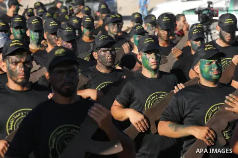 Young Palestinians, carrying a wooden rifle, chants slogans during a military-style graduation ceremony organised by the Islamic Jihad movement in Gaza City on July 4, 2019. Photo by Ashraf Amra