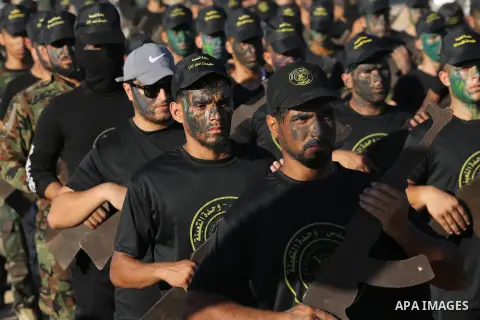 Young Palestinians, carrying a wooden rifle, chants slogans during a military-style graduation ceremony organised by the Islamic Jihad movement in Gaza City on July 4, 2019. Photo by Ashraf Amra