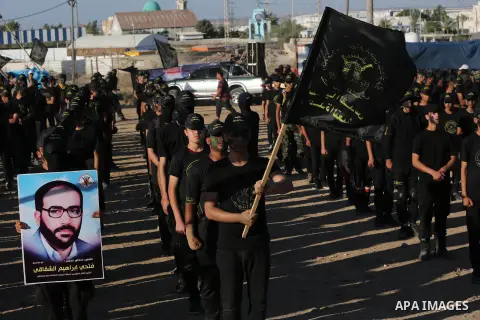 Young Palestinians, carrying a wooden rifle, chants slogans during a military-style graduation ceremony organised by the Islamic Jihad movement in Gaza City on July 4, 2019. Photo by Ashraf Amra