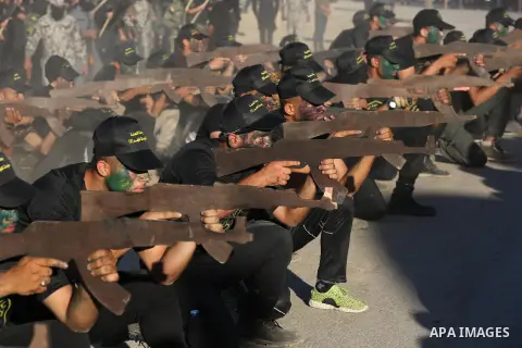 Young Palestinians, carrying a wooden rifle, chants slogans during a military-style graduation ceremony organised by the Islamic Jihad movement in Gaza City on July 4, 2019. Photo by Ashraf Amra