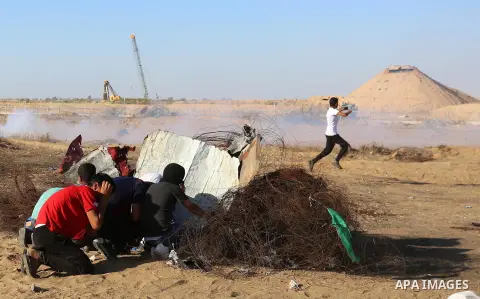 Palestinian protesters clash with Israeli troops following the tents protest where Palestinians demand the right to return to their homeland at the Israel-Gaza border, in Khan Younis in the southern Gaza Strip, July 05,...