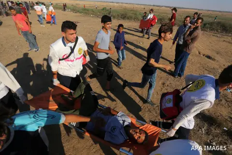 A wounded Palestinian protester is evacuated during clashes with Israeli troops following the tents protest where Palestinians demand the right to return to their homeland at the Israel-Gaza border, in Khan Younis in the...