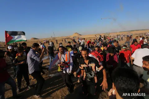 A wounded Palestinian protester is evacuated during clashes with Israeli troops following the tents protest where Palestinians demand the right to return to their homeland at the Israel-Gaza border, in Khan Younis in the...