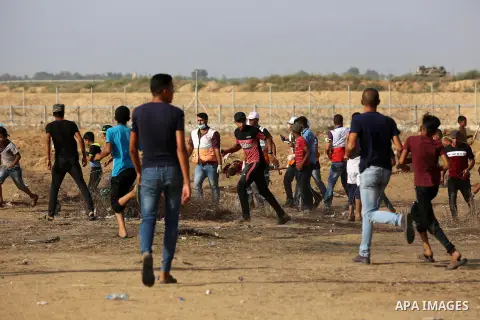 Palestinian protesters clash with Israeli troops following the tents protest where Palestinians demand the right to return to their homeland at the Israel-Gaza border, in Khan Younis in the southern Gaza Strip, July 12,...