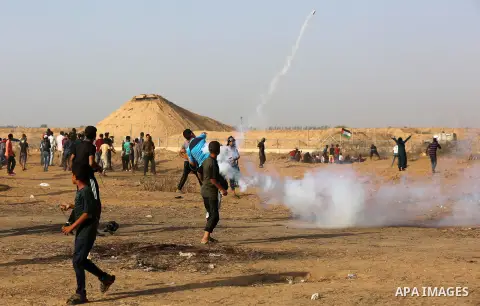 Palestinian protesters clash with Israeli troops following the tents protest where Palestinians demand the right to return to their homeland at the Israel-Gaza border, in Khan Younis in the southern Gaza Strip, July 12,...