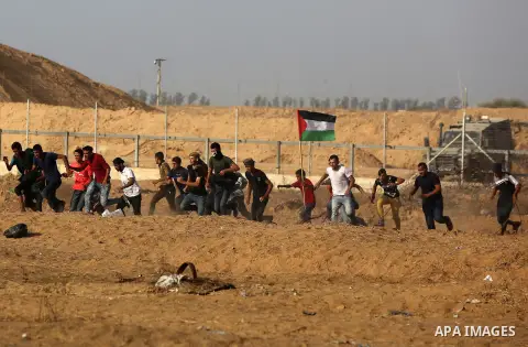 Palestinian protesters clash with Israeli troops following the tents protest where Palestinians demand the right to return to their homeland at the Israel-Gaza border, in Khan Younis in the southern Gaza Strip, July 12,...