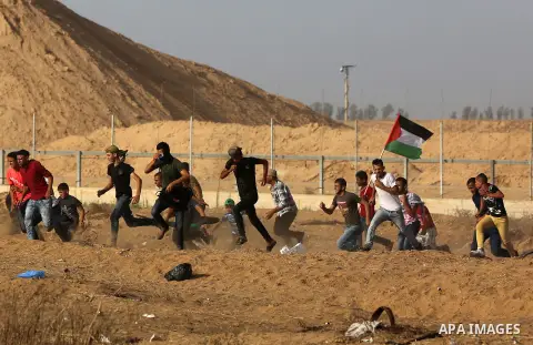 Palestinian protesters clash with Israeli troops following the tents protest where Palestinians demand the right to return to their homeland at the Israel-Gaza border, in Khan Younis in the southern Gaza Strip, July 12,...