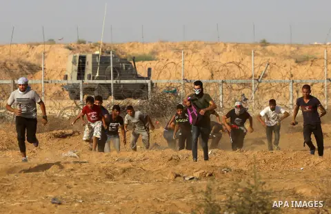 Palestinian protesters clash with Israeli troops following the tents protest where Palestinians demand the right to return to their homeland at the Israel-Gaza border, in Khan Younis in the southern Gaza Strip, July 12,...