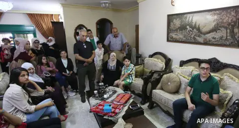 A Palestinian high school male student, Daoud Hamdan, 99.7%, celebrates with his family after heard the results of his final exams known as ''Tawjihi'', in the West Bank city of Nanlus, on July 18, 2019. Photo by Shadi J...