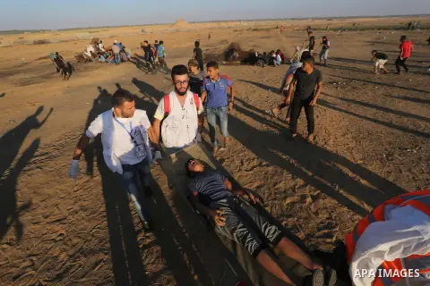 A wounded Palestinian protester is evacuated during clashes with Israeli troops following the tents protest where Palestinians demand the right to return to their homeland at the Israel-Gaza border, in Khan Younis in the...