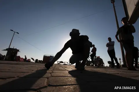 Moawia Ashour, 24, a Palestinian man uses coal to draw on the ground near his street cafe, at the beach of Gaza city, July 30, 2019. Photo by Mahmoud Ajjour