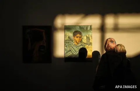 Palestinians attend the art show of Contemplative Contrasts, organised by General Union of Cultural centers, in Gaza city on July 30, 2019. Photo by Mahmoud Al-Hindi