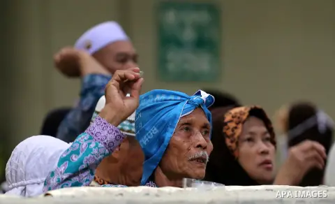 Muslim pilgrims throw pebbles at pillars during the "Jamarat" ritual, the stoning of Satan, in Mina near the holy city of Mecca, on August 12, 2019. Pilgrims pelt pillars symbolizing the devil with pebbles to show their...