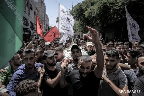 Mourners carry the body of Palestinian Mahmoud Al-walayda, one of three armed Palestinians killed overnight in Israeli fire along the border with the Gaza Strip, mourn during his funeral in Beit Lahya in northern Gaza st...