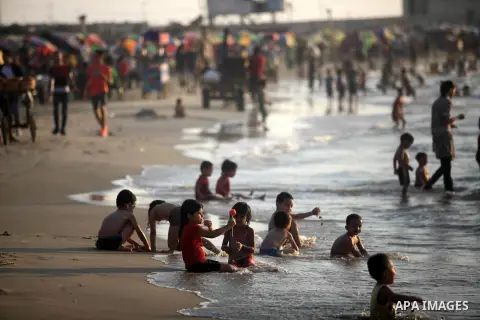 Palestinians enjoy at the beach along the shore of the Mediterranean Sea, two days before back to school, in Gaza City on August 23, 2019. Photo by Mahmoud Ajjour