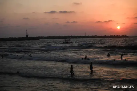 Palestinians enjoy at the beach along the shore of the Mediterranean Sea, two days before back to school, in Gaza City on August 23, 2019. Photo by Mahmoud Ajjour