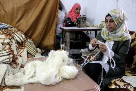 Palestinian woman make body loofahs at their house in the West Bank city of Hebron, on 27 August 2019. The fully developed fruit is the source of the loofah scrubbing sponge which is used in bathrooms and kitchens. Photo...