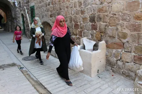 Palestinian woman make body loofahs at their house in the West Bank city of Hebron, on 27 August 2019. The fully developed fruit is the source of the loofah scrubbing sponge which is used in bathrooms and kitchens. Photo...