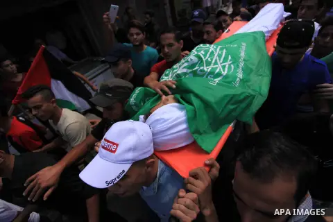 Mourners carry the body of Palestinian Khaled al-Rabie, 14, who was shot dead by Israeli forces at the Israel-Gaza border, during his funeral in Gaza city, on September 7, 2019. Photo by Mahmoud Ajjour