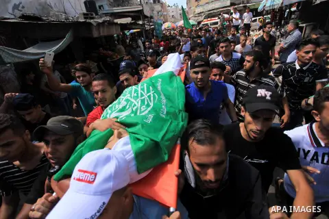 Mourners carry the body of Palestinian Khaled al-Rabie, 14, who was shot dead by Israeli forces at the Israel-Gaza border, during his funeral in Gaza city, on September 7, 2019. Photo by Mahmoud Ajjour