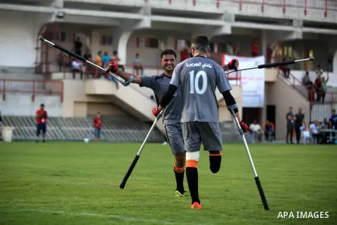 Palestinian amputees using crutches compete during the Palestinian League football match, at Palestine Stadium in Gaza city, September 10, 2019. Photo by Mahmoud Ajjour