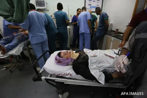 A Palestinian role-playing as an injured person is transported on a moving hospital bed into a hospital during an emergency drill for treating mass casualties organised by French humanitarian organisation Medecins du Mon...