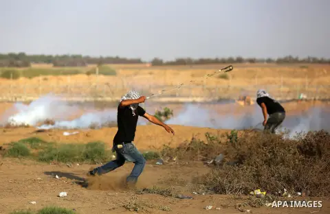Palestinian protesters clash with Israeli troops following the tents protest where Palestinians demand the right to return to their homeland at the Israel-Gaza border, in Khan Younis in the southern Gaza Strip, Spetember...
