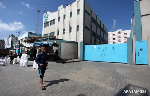 A Palestinian man carries a bag of flour to distribute to families, at an aid distribution centre of the United Nations Relief and Works Agency (UNRWA) in Jabalia in the northern Gaza Strip, on SEP. 21, 2019. Photo by Ma...