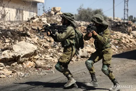 Israeli security forces take position during clashes with Palestinian protesters following a weekly demonstration against the expropriation of Palestinian land by Israel in the village of Kfar Qaddum, near the West Bank...
