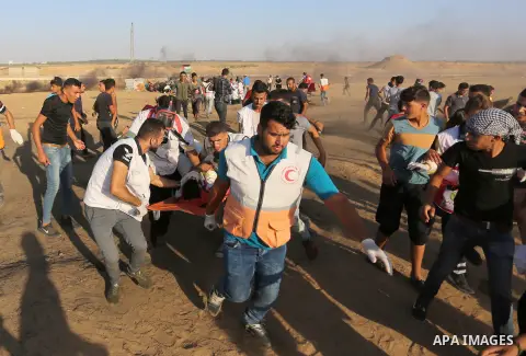 A wounded Palestinian protester is evacuated during clashes with Israeli troops following the tents protest where Palestinians demand the right to return to their homeland at the Israel-Gaza border, in Khan Younis in the...