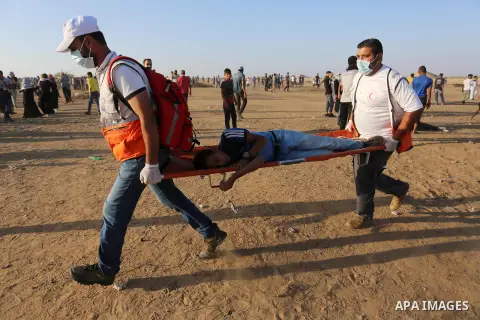 A wounded Palestinian protester is evacuated during clashes with Israeli troops following the tents protest where Palestinians demand the right to return to their homeland at the Israel-Gaza border, in Khan Younis in the...