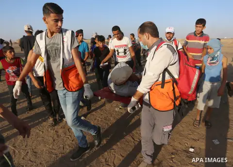 A wounded Palestinian protester is evacuated during clashes with Israeli troops following the tents protest where Palestinians demand the right to return to their homeland at the Israel-Gaza border, in Khan Younis in the...
