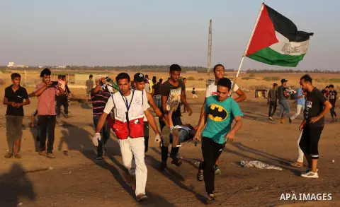 A wounded Palestinian protester is evacuated during clashes with Israeli troops following the tents protest where Palestinians demand the right to return to their homeland at the Israel-Gaza border, in Khan Younis in the...
