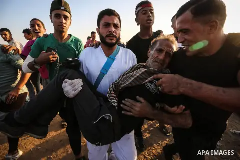 A wounded Palestinian protester is evacuated during clashes with Israeli troops following the tents protest where Palestinians demand the right to return to their homeland at the Israel-Gaza border, in Khan Younis in the...