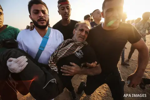 A wounded Palestinian protester is evacuated during clashes with Israeli troops following the tents protest where Palestinians demand the right to return to their homeland at the Israel-Gaza border, in Khan Younis in the...