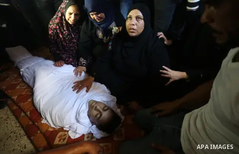 Mourners carry the body of Palestinian Saher Othman, 20, who was died of his wounds which he sustained by Israeli forces during clashes in tents protest where Palestinians demand the right to return to their homeland at...