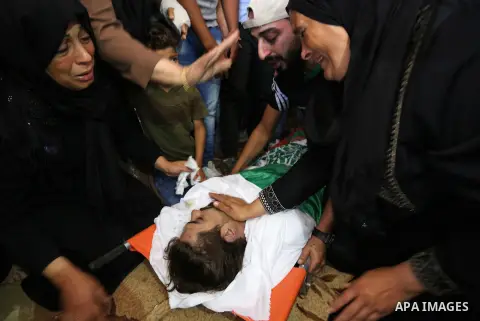 Mourners carry the body of Palestinian Fadi Hijazi, 21, who was died of his wounds which he sustained in February of this year by Israeli forces during clashes in tents protest where Palestinians demand the right to retu...