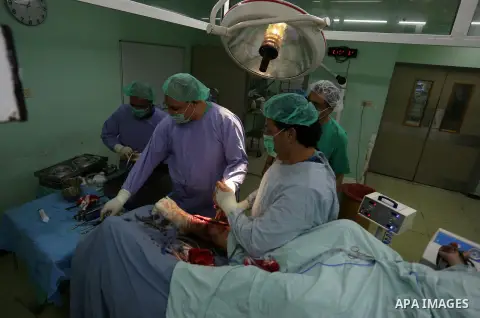 Egyptian doctors take part in surgery for a Palestinian, who was injured during the clashes with Israeli troops at the European Gaza Hospital in Khan Yunis in the southern Gaza Strip, on October 12, 2019. Photo by Ashraf...