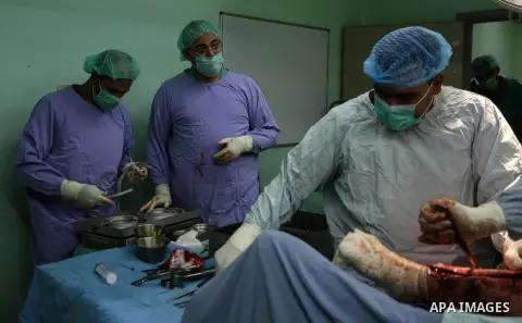 Egyptian doctors take part in surgery for a Palestinian, who was injured during the clashes with Israeli troops at the European Gaza Hospital in Khan Yunis in the southern Gaza Strip, on October 12, 2019. Photo by Ashraf...