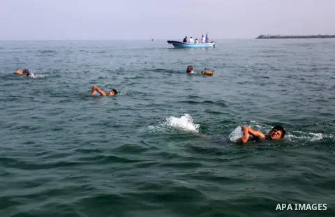 Palestinian children swim in the Mediterranean Sea during a swimming lesson in Gaza City on October 15, 2019. Photo by Mahmoud Ajjour
