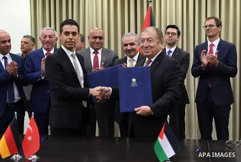 Palestinian Prime Minister Mohammad Ishtayeh signs a contract for the implementation of infrastructure works for the project "Jenin Free Industrial Zone" in the West Bank city of Ramallah, on October 17, 2019. Photo by P...