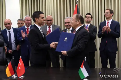 Palestinian Prime Minister Mohammad Ishtayeh signs a contract for the implementation of infrastructure works for the project "Jenin Free Industrial Zone" in the West Bank city of Ramallah, on October 17, 2019. Photo by P...
