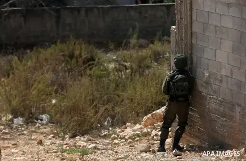 Israeli security forces take position during clashes with Palestinian protesters following a weekly demonstration against the expropriation of Palestinian land by Israel in the village of Kfar Qaddum, near the West Bank...