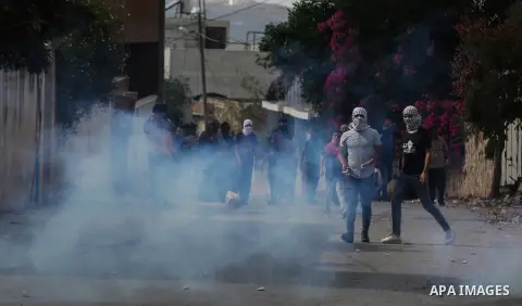 Palestinian protesters hurl stones towards Israeli security forces during clashes following a weekly demonstration against the expropriation of Palestinian land by Israel in the village of Kfar Qaddum, near the West Bank...